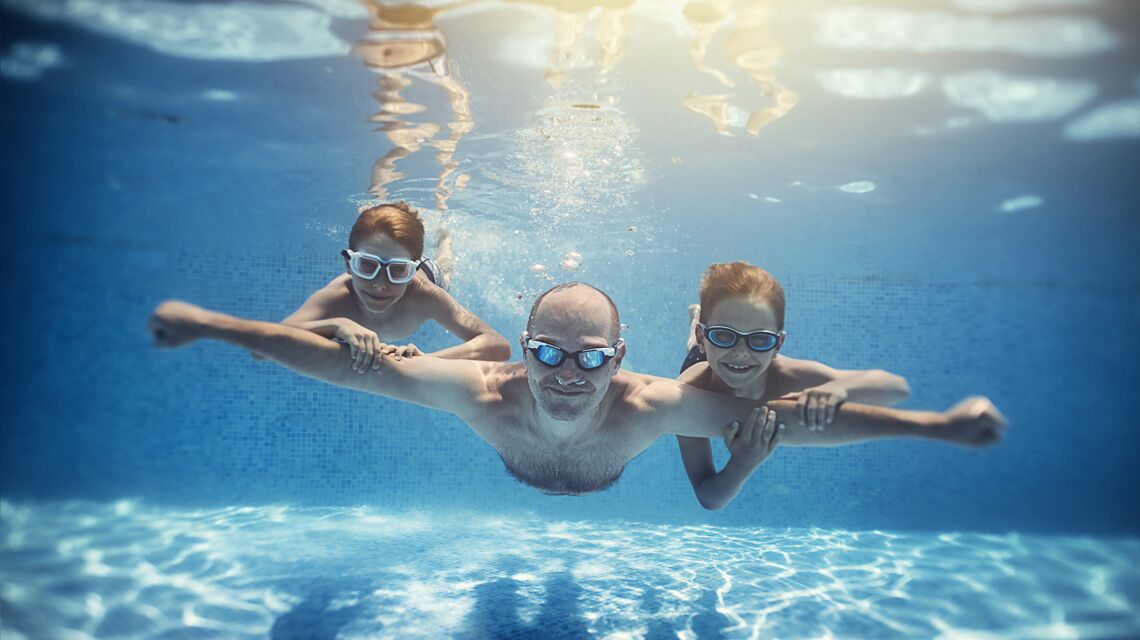 A family swimming underwater together